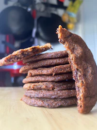 a stack of chocolate chip cookies on a table